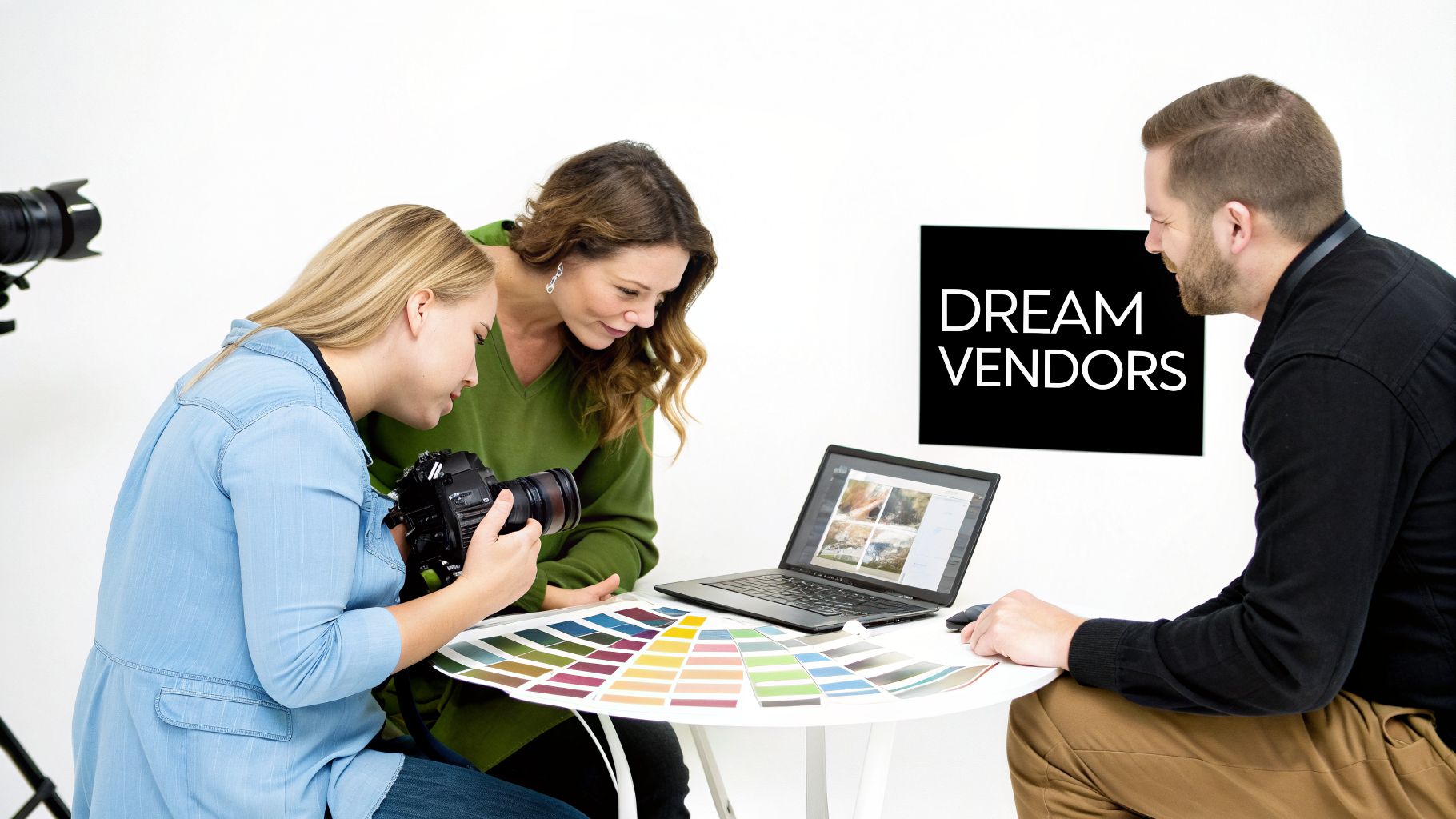 Three professionals discuss photography and design, reviewing a camera, laptop, and color palette. A 'DREAM VENDORS' sign is visible.