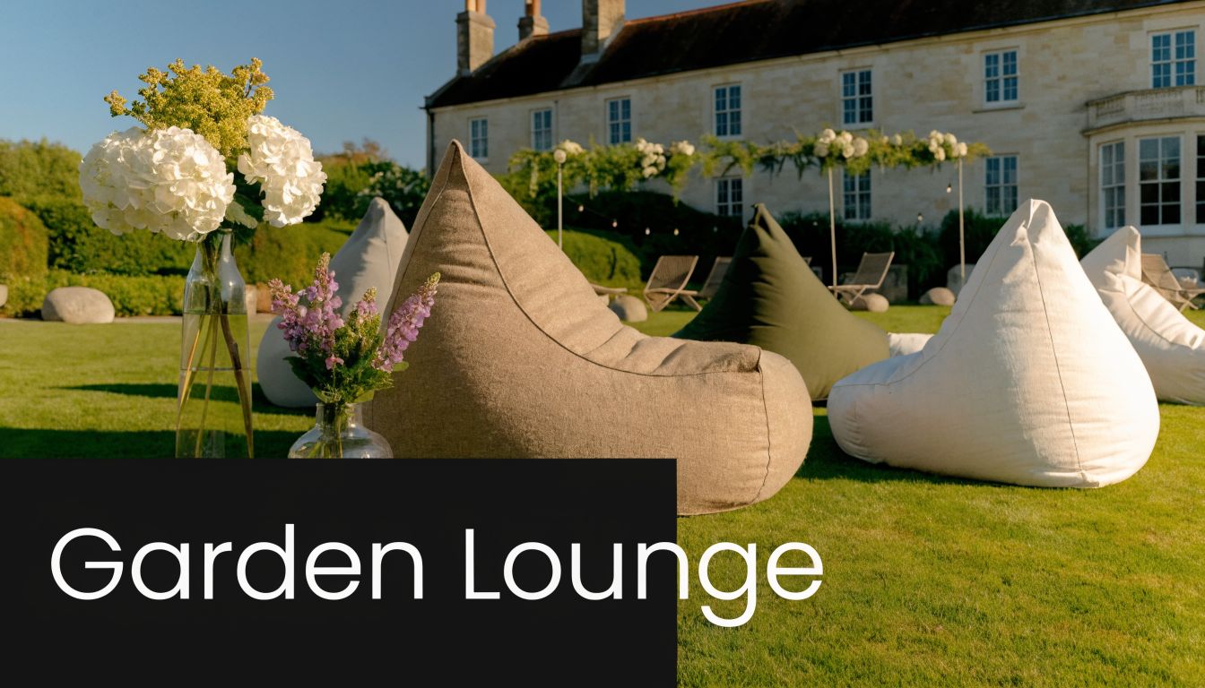 An outdoor garden lounge area with comfortable bean bag chairs and floral arrangements on a sunny lawn.