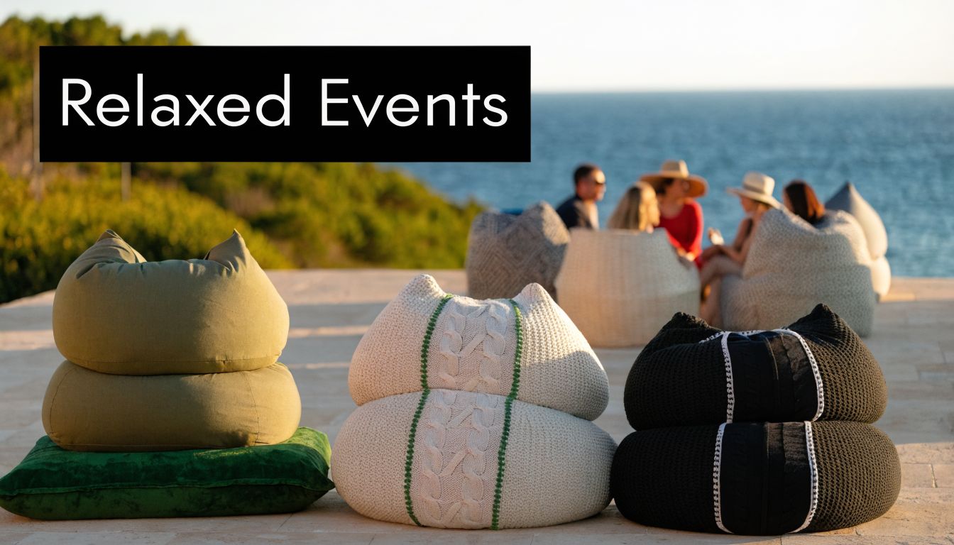 A group of people sitting on large bean bags on a terrace overlooking the ocean at sunset.
