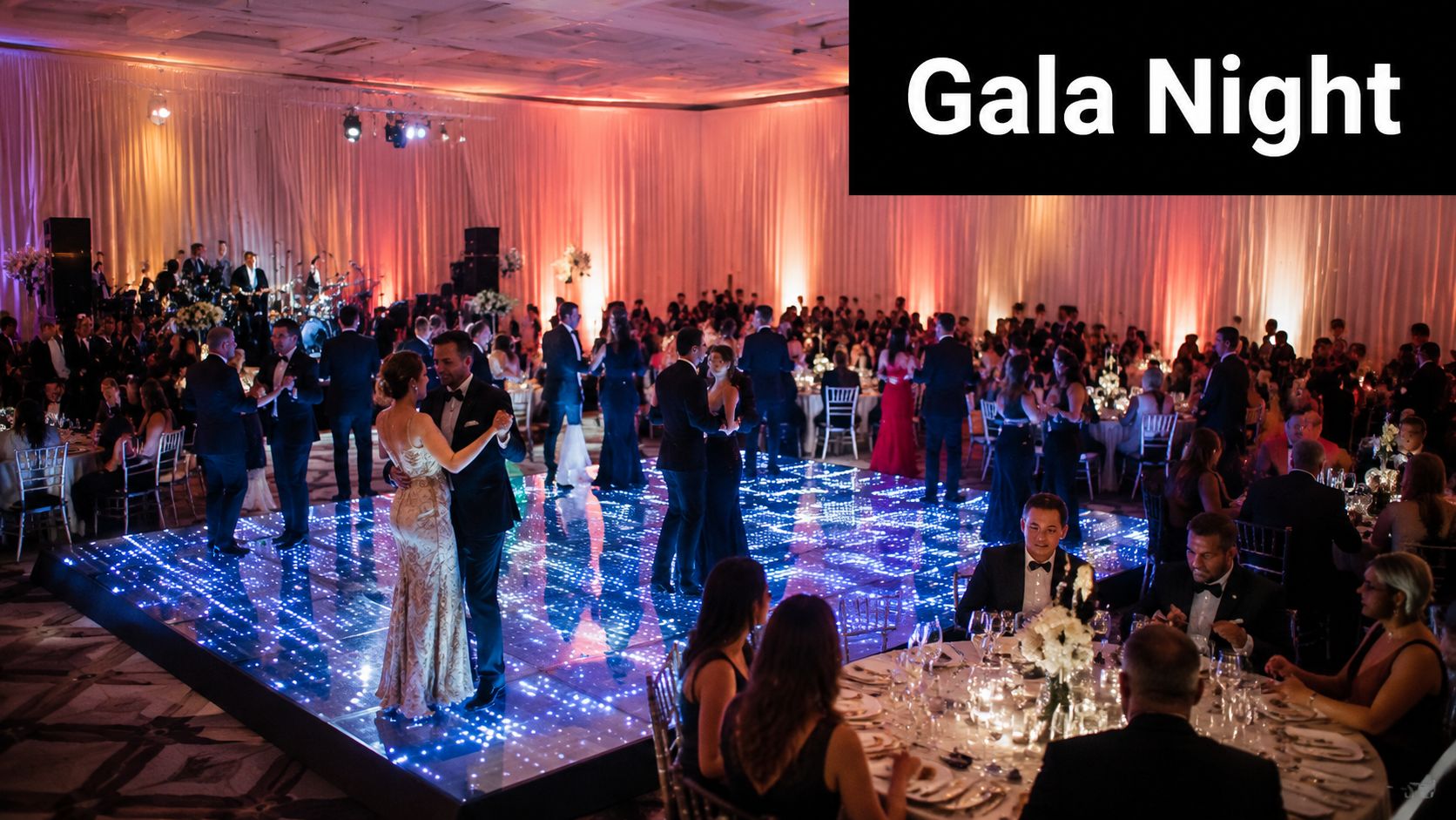 Elegant guests dancing on a glowing LED dance floor at a sophisticated gala dinner event.