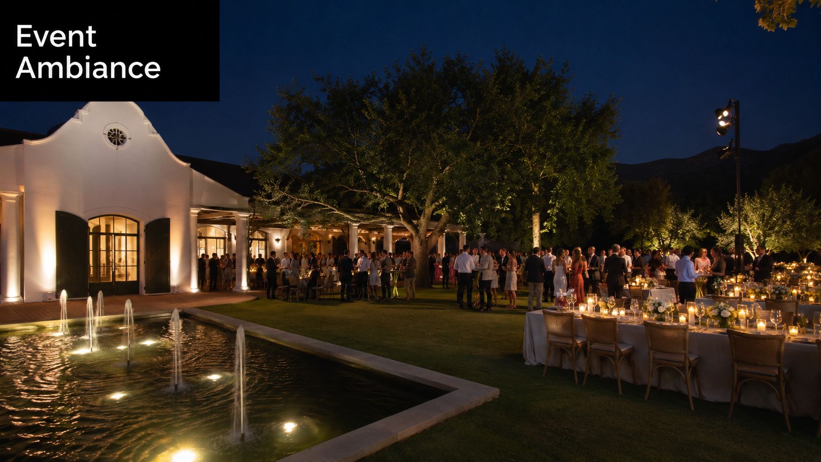 A luxurious evening garden party featuring illuminated dining tables and a fountain outside a white building.