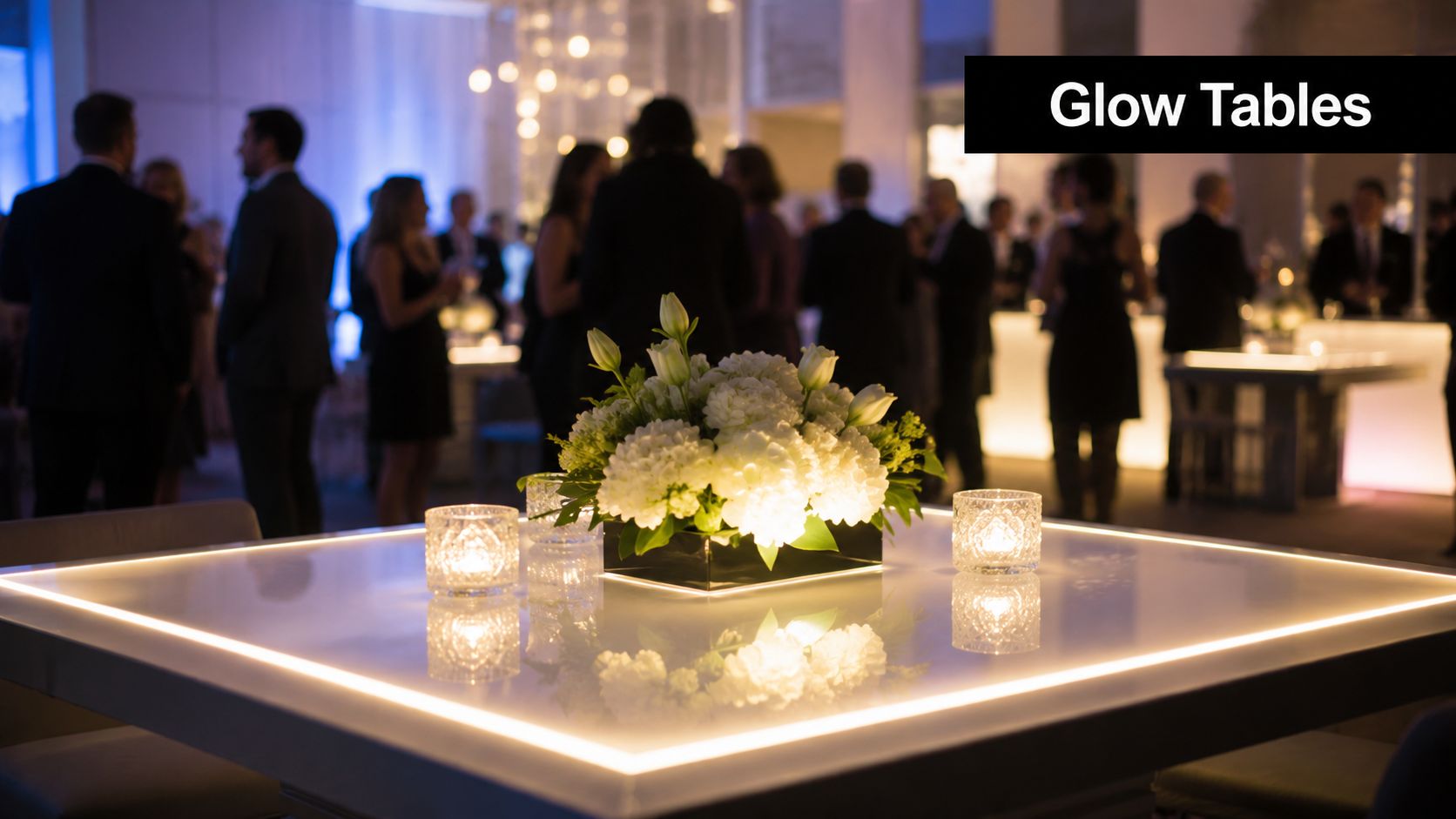 Elegant event party table with a white glowing edge and a centerpiece of fresh white flowers.